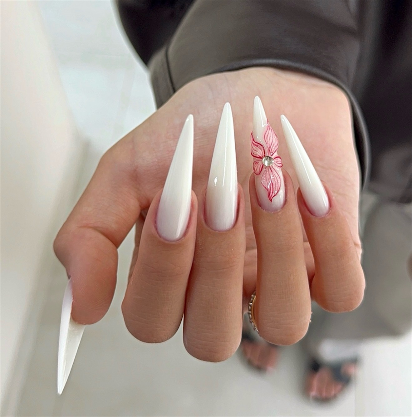 Delicate White Stiletto Nails with Pink Flower Art