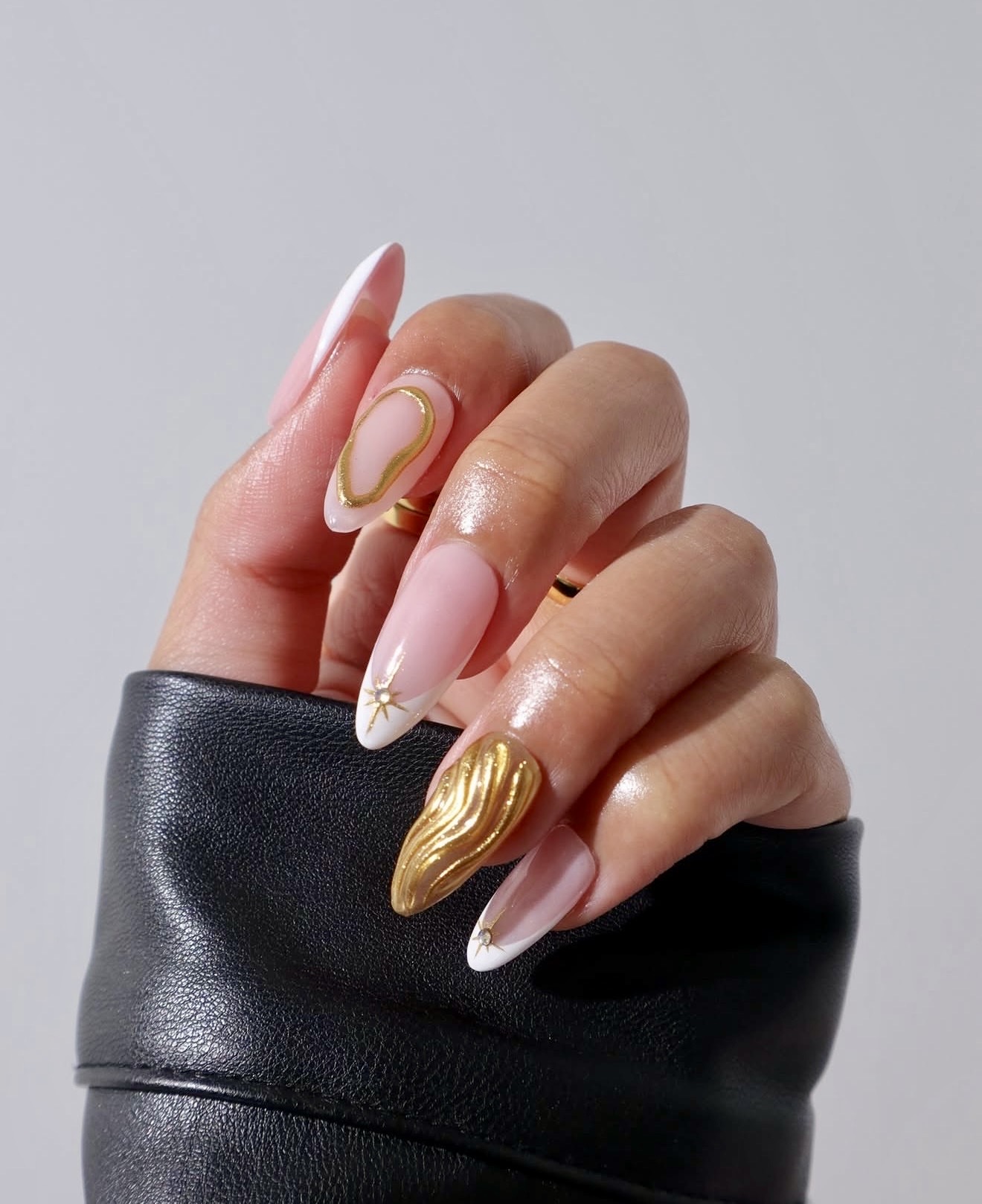 Gilded French Tip Almond Nails with Abstract Art