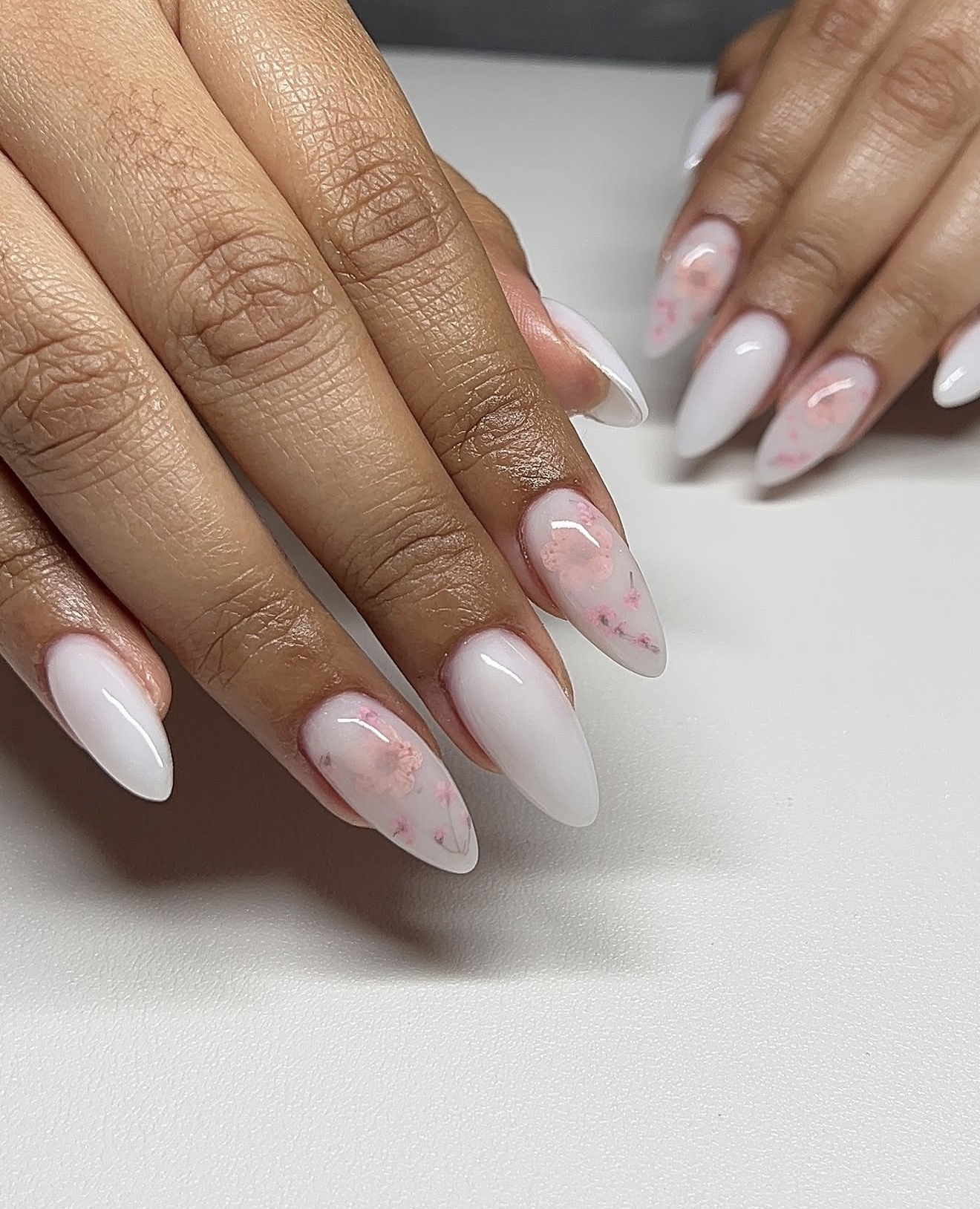 Milky White Almond Nails with Delicate Floral Accents