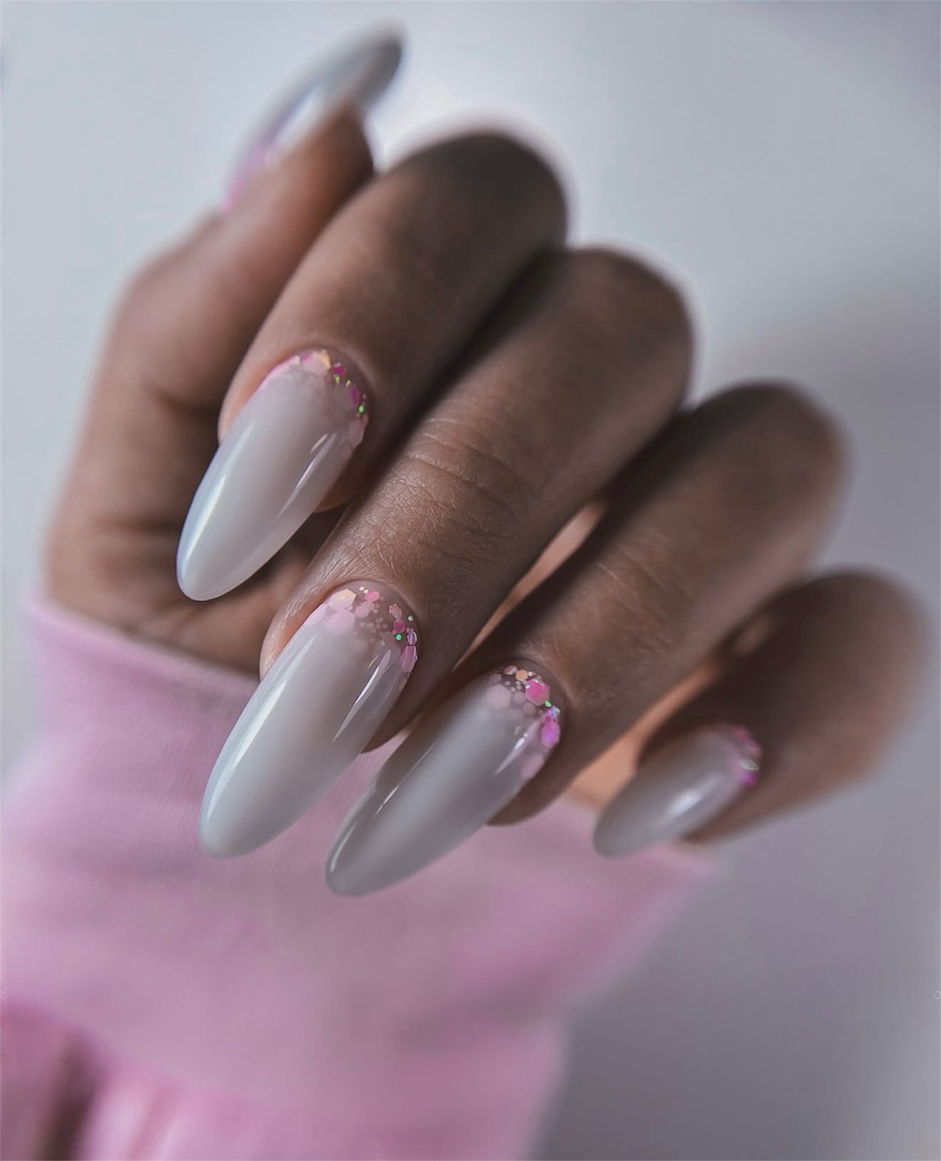 Milky White Almond Nails with Pink Glitter French Accent