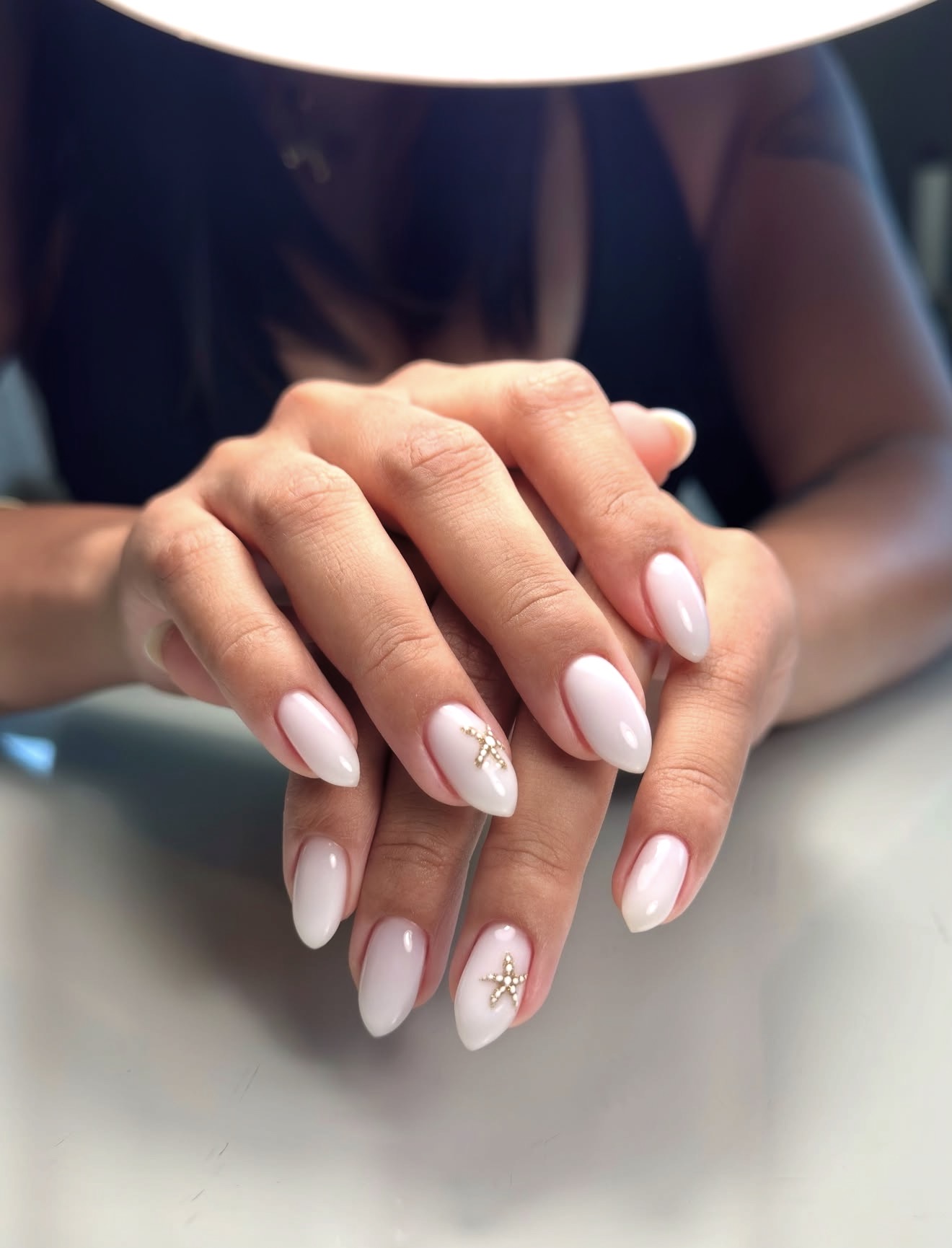 Milky White Almond Nails with Star Accents