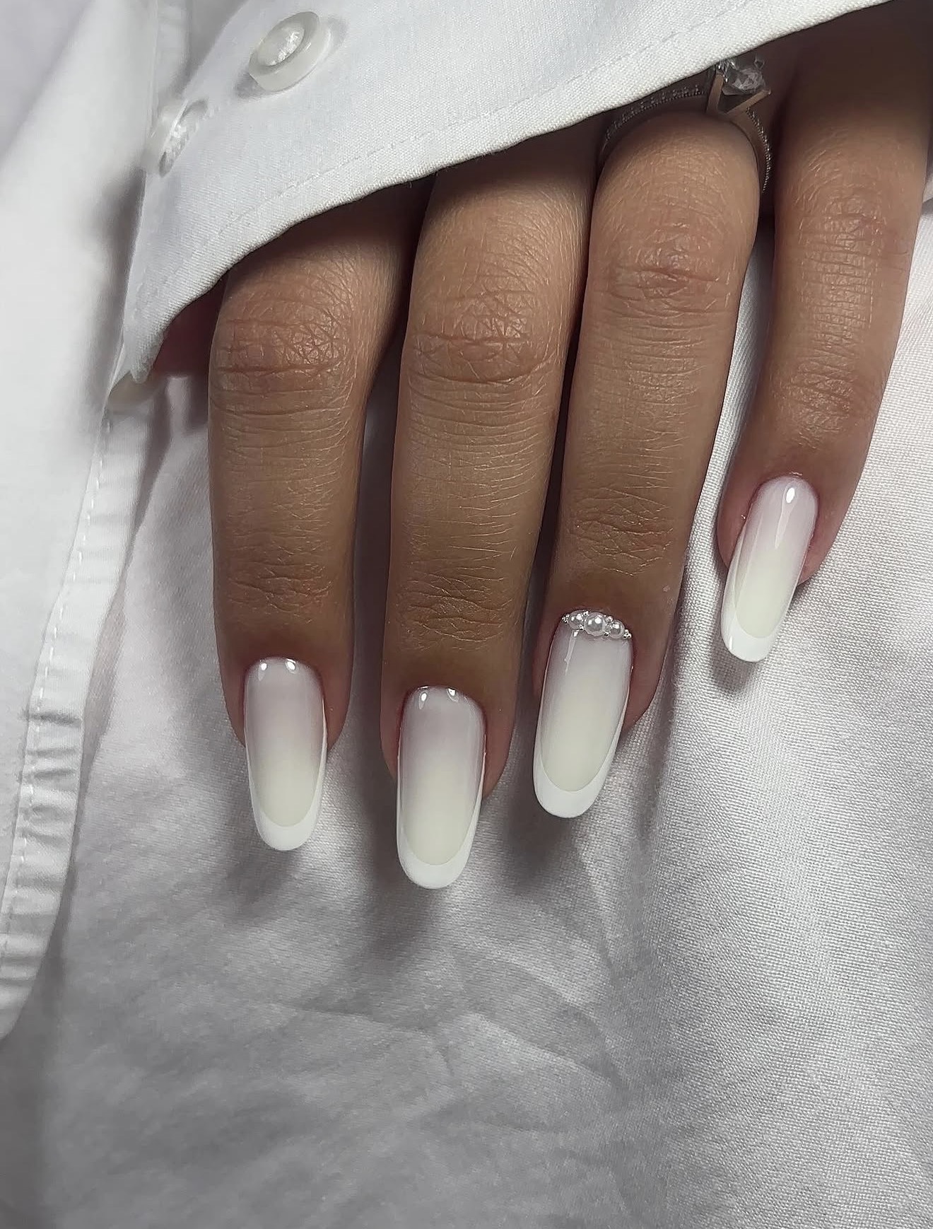 Milky White Ombre Oval Nails with Pearl Accents