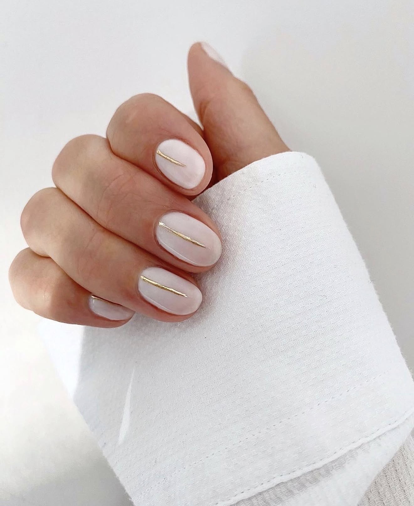 Milky White Oval Nails with Gold Line Art