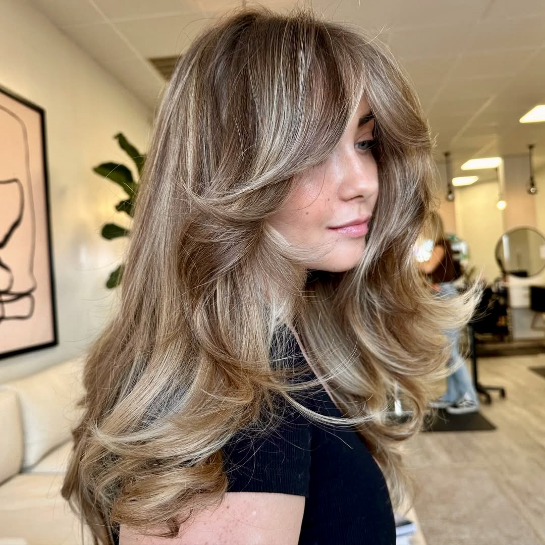 Voluminous Honey Blonde Layers With Face-Framing Bangs