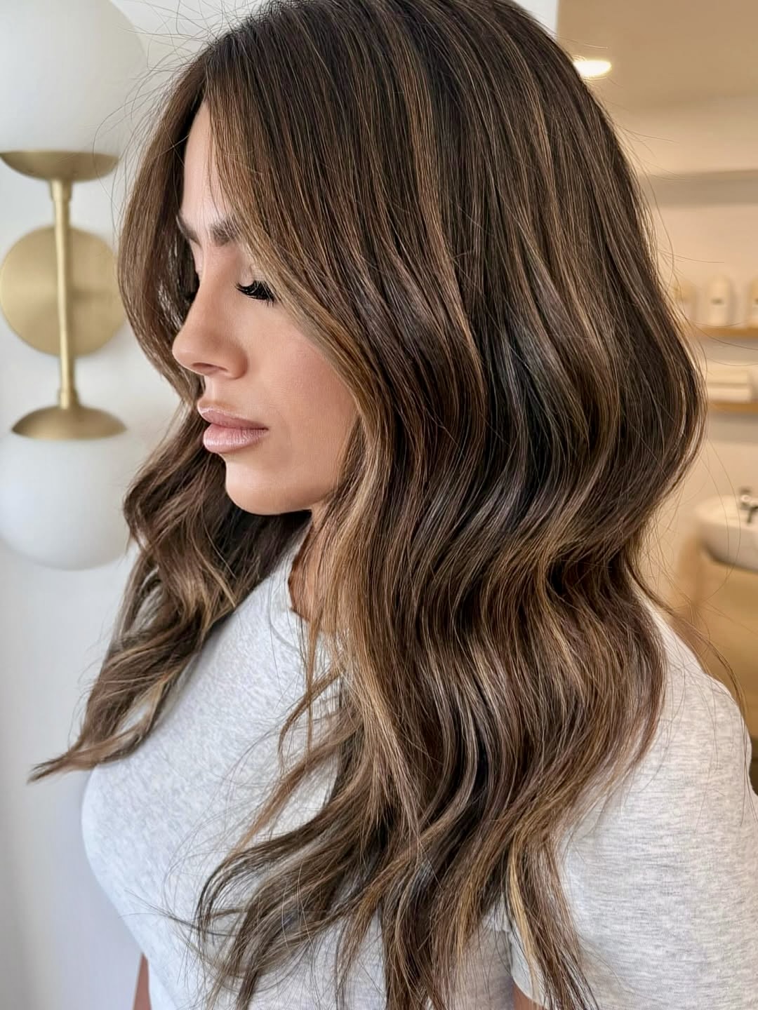 Warm Brunette Balayage With Face-Framing Waves
