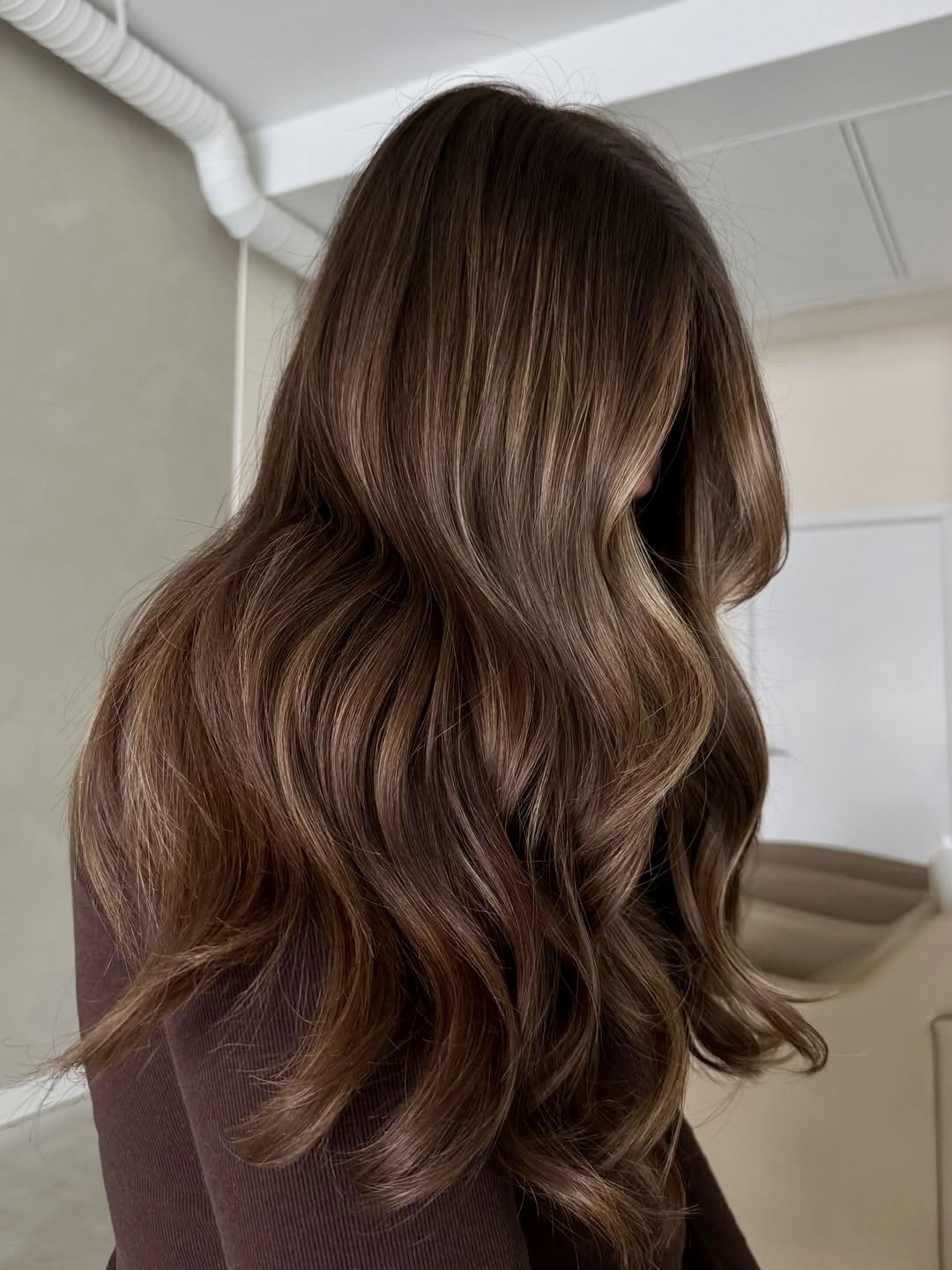 Warm Brunette Balayage With Polished Waves