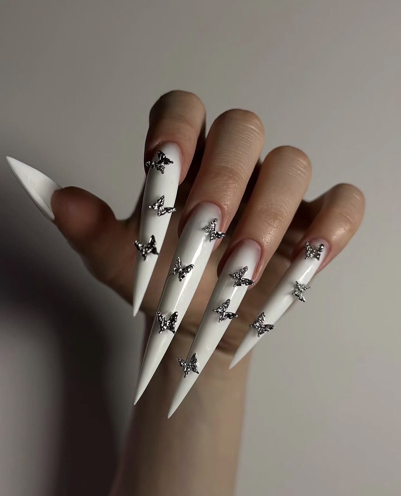 White Stiletto Nails with Silver Butterfly Charms