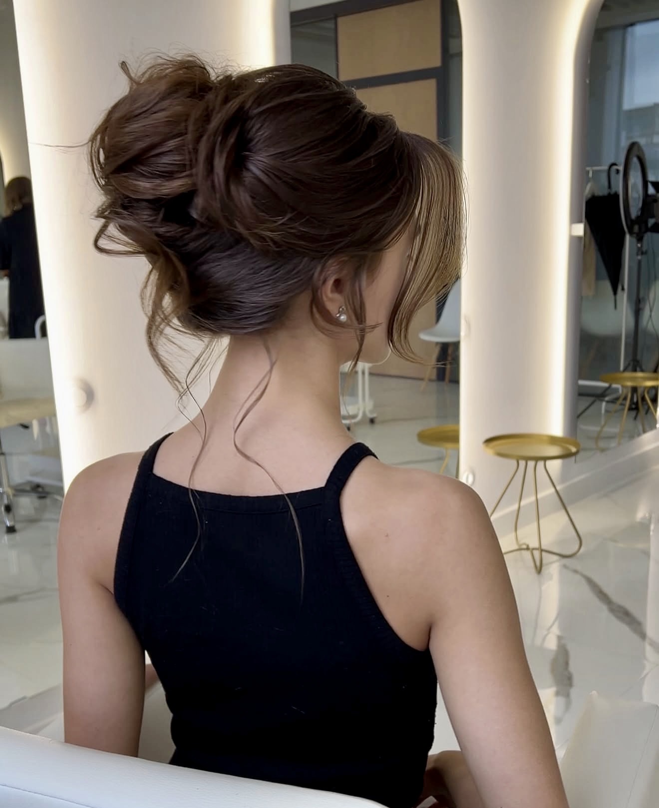 Achieve Elegant Tousled Low Bun With Face-Framing Strands