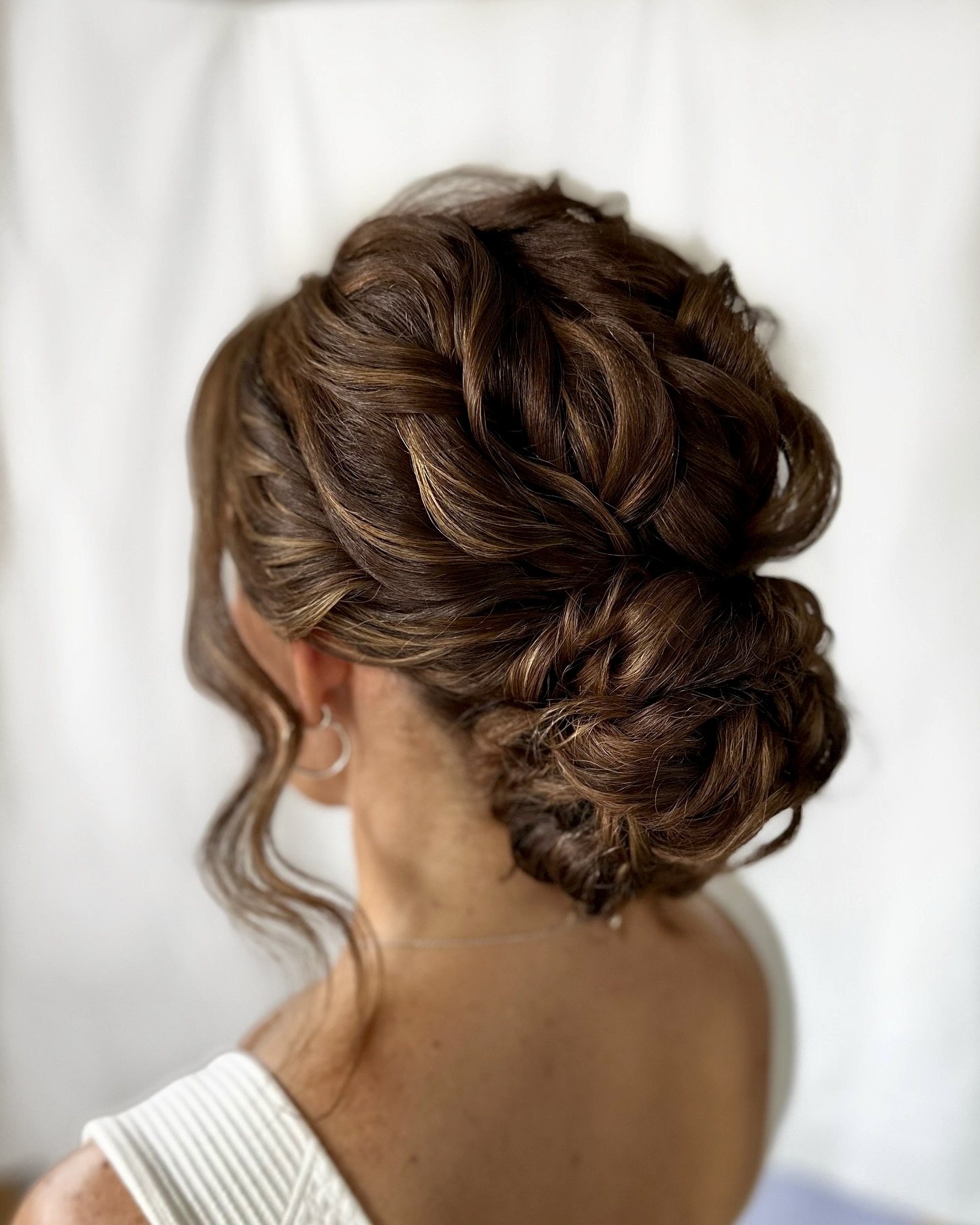 Braided Updo With Loose Face-Framing Waves