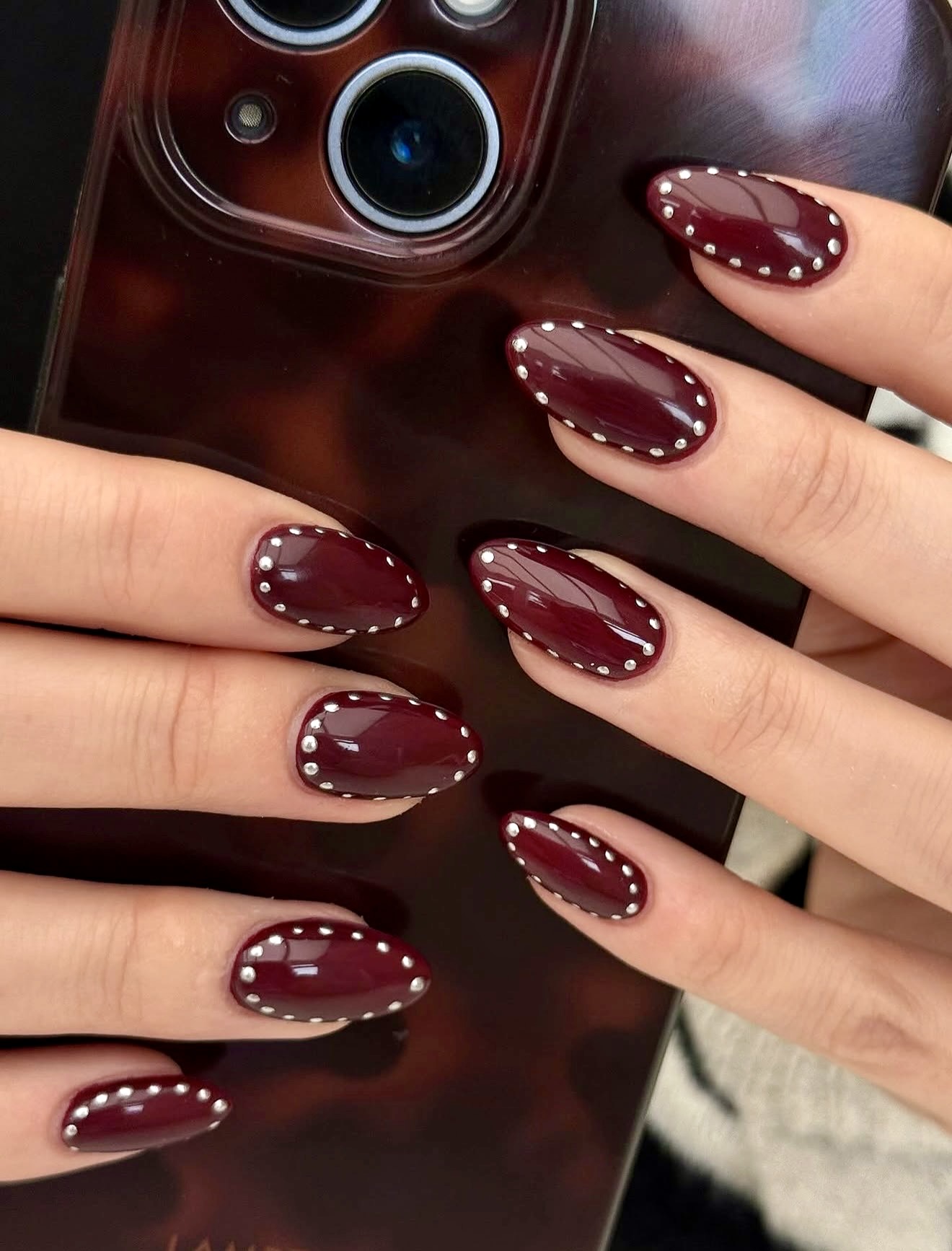 Burgundy Oval Nails with Silver Stud Accents