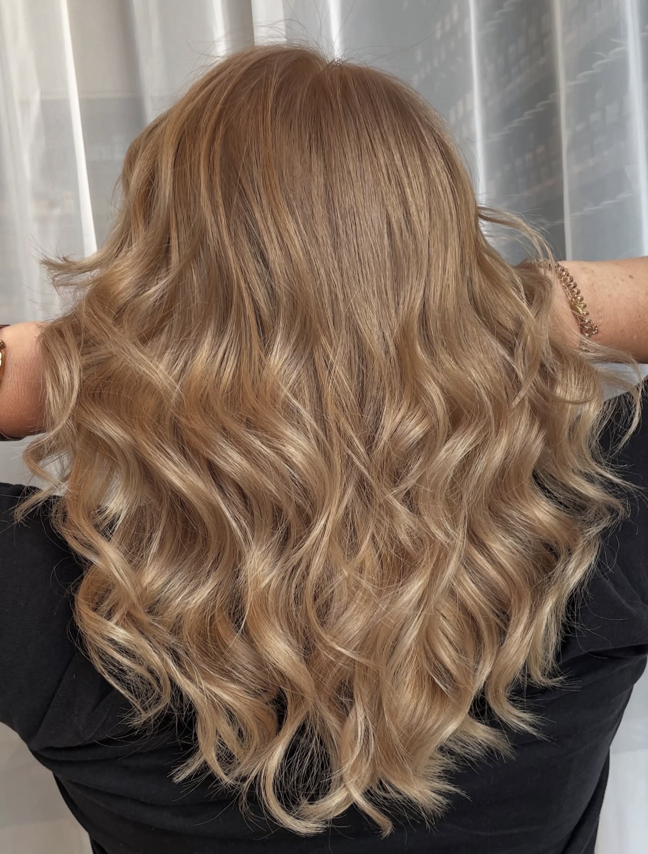 Cascading Honey Blonde Waves With Subtle Layers