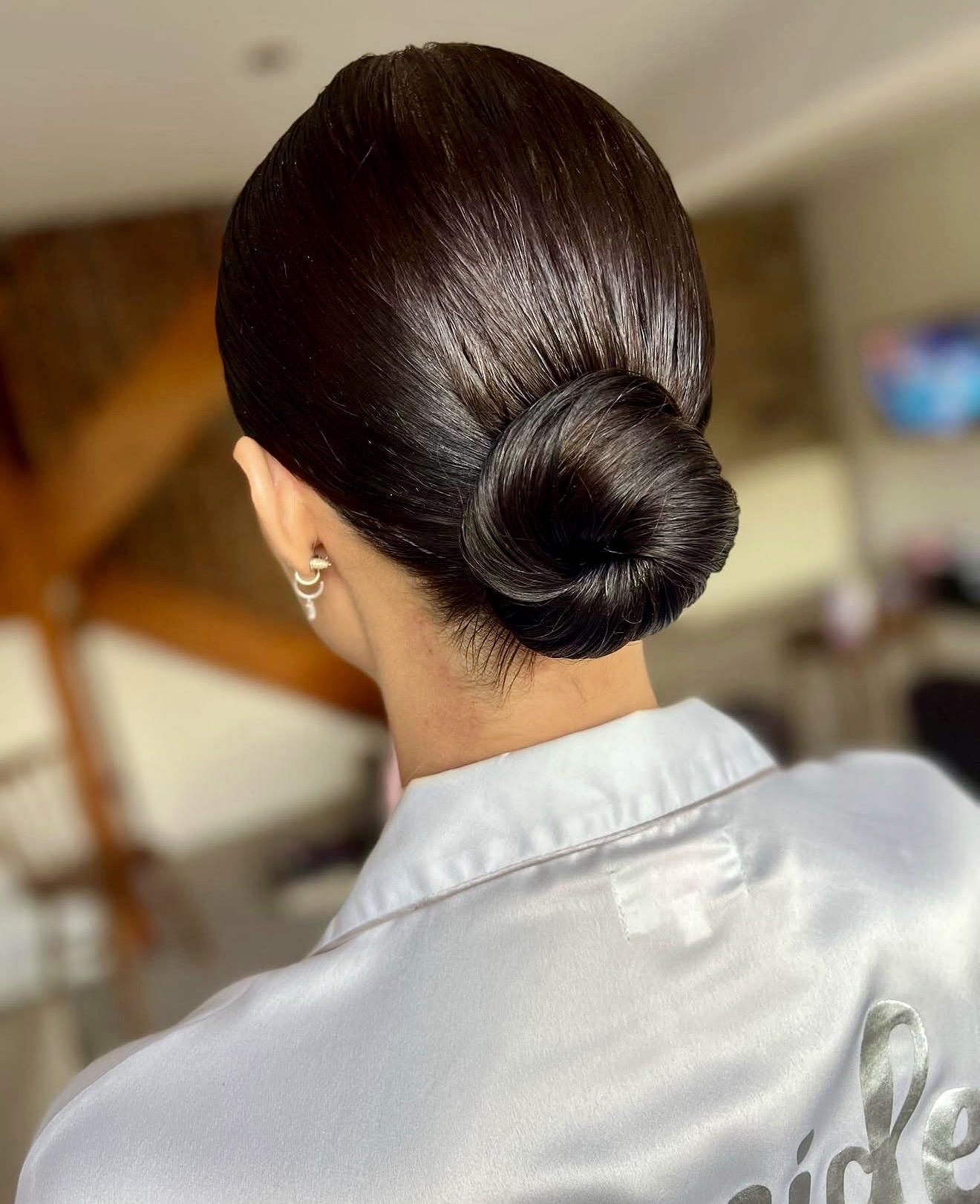 Chic Sleek Low Bun With A Glossy Finish