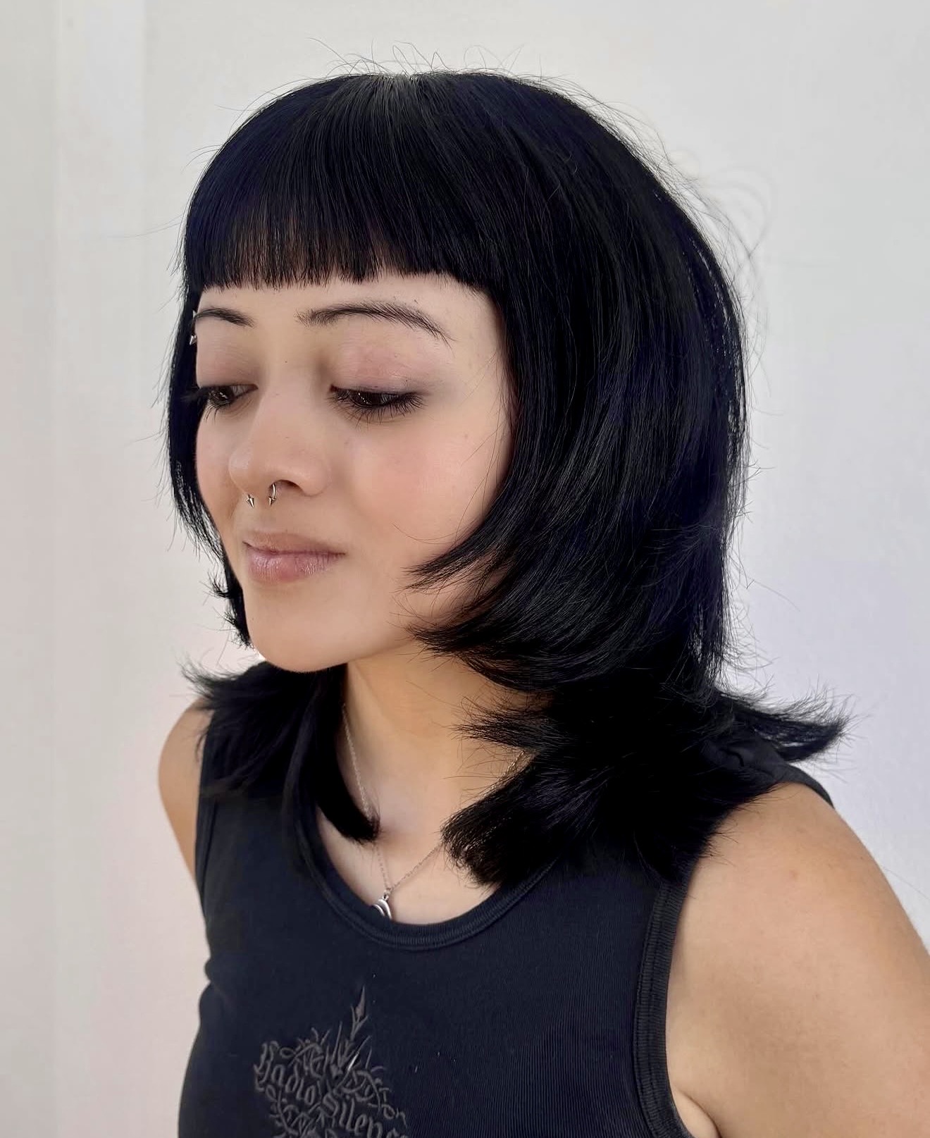 Choppy Black Wolf Cut With Micro Bangs