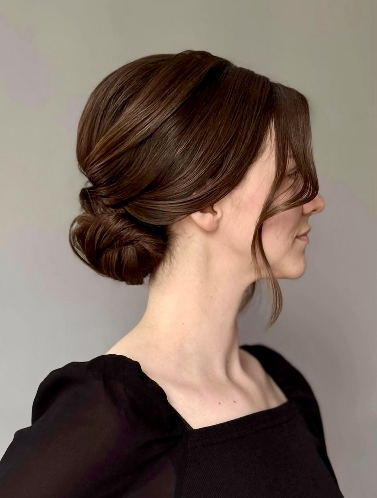 Elegant Low Twisted Bun With Face Framing Strands