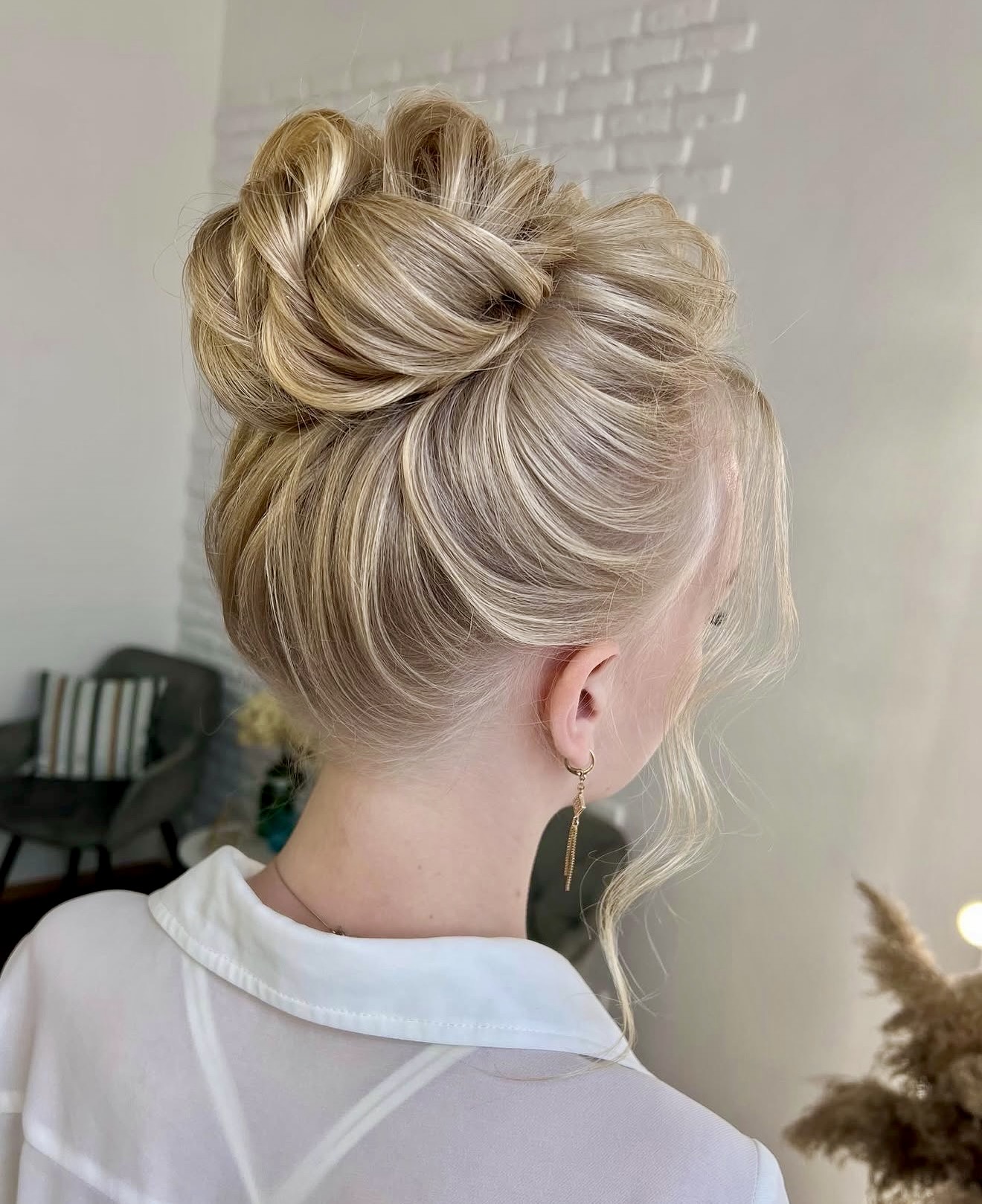 Elegant Twisted High Bun With Face-Framing Tendrils
