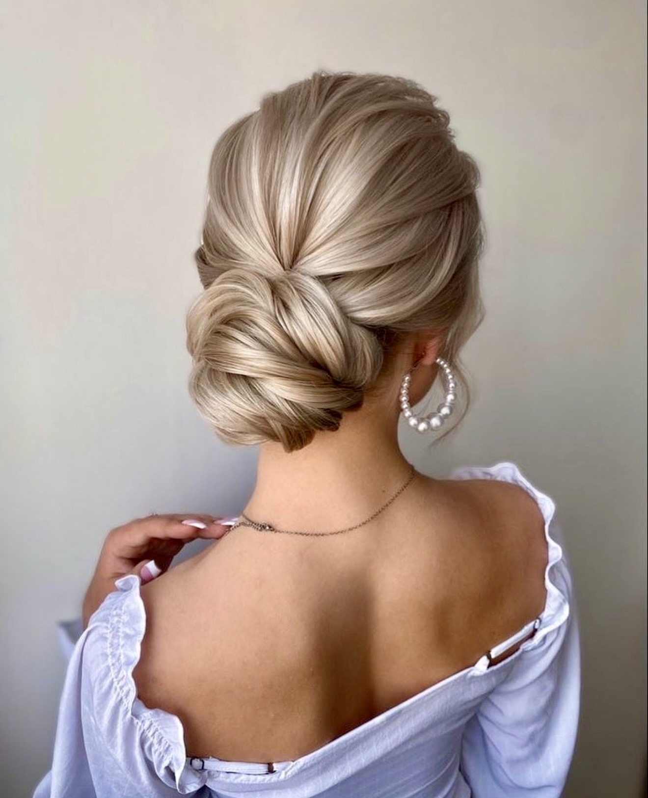 Elegant Twisted Low Bun With Blonde Highlights