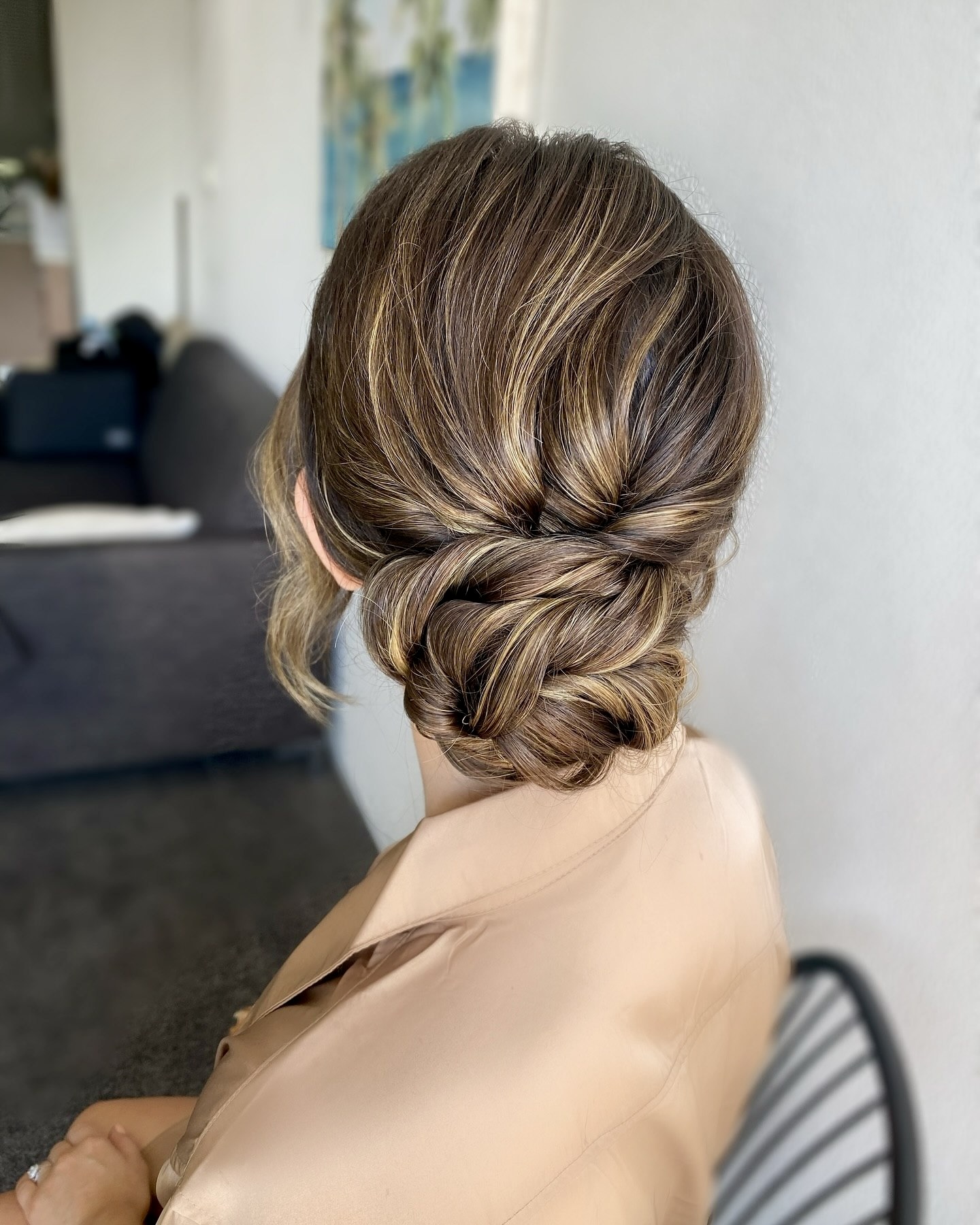 Elegant Twisted Low Bun With Honey Blonde Highlights