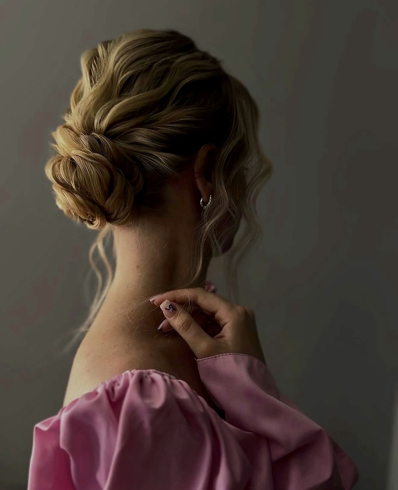 Elegant Twisted Low Bun With Loose Scurl Strands