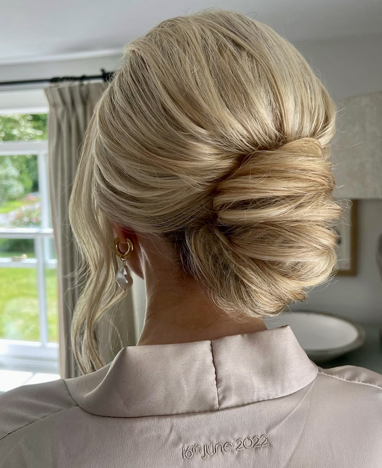 Elegant Twisted Low Bun With Wispy Face Framing Strands