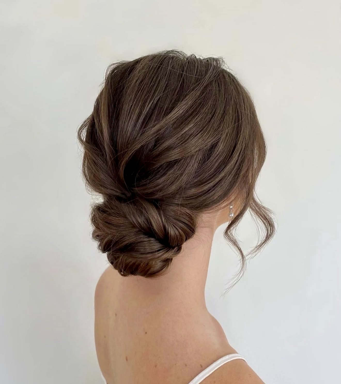 Elegant Twisted Low Bun With Wispy Strands