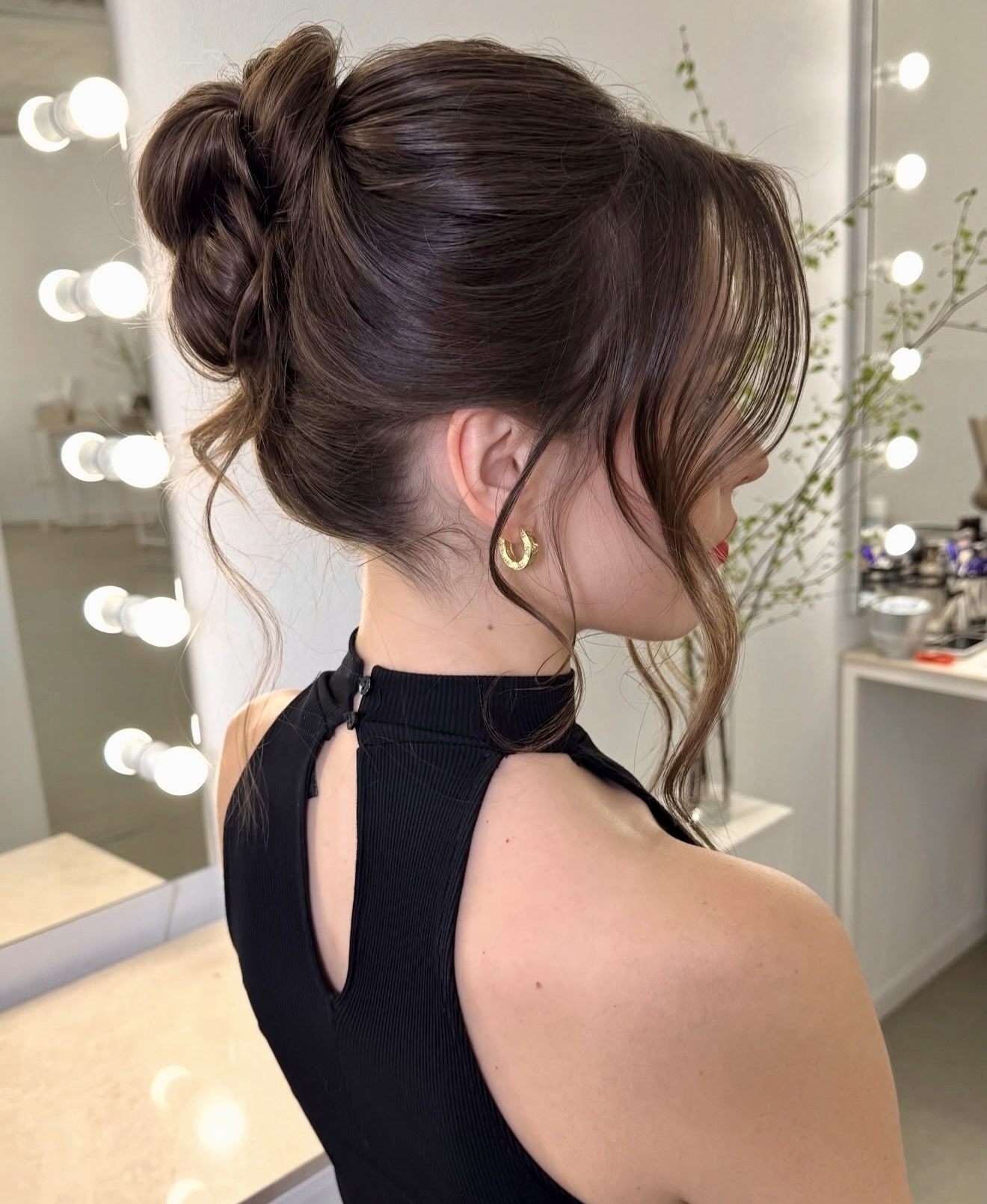 Elegant Wavy Low Bun With Face-Framing Strands