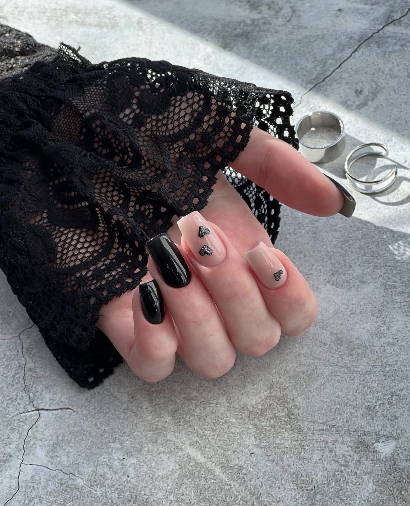 Glossy Black and Nude Nails with Glitter Hearts