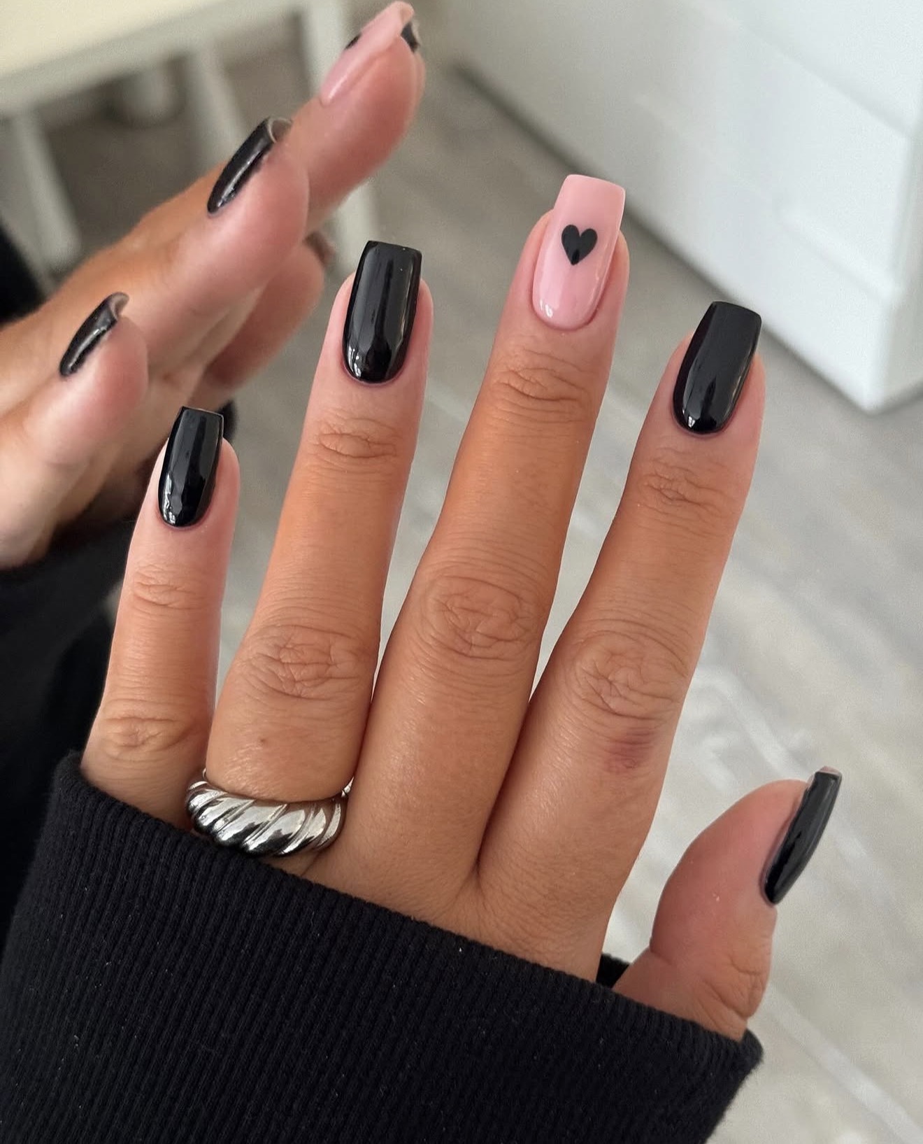 Glossy Black Nails with Pastel Pink Heart Accent