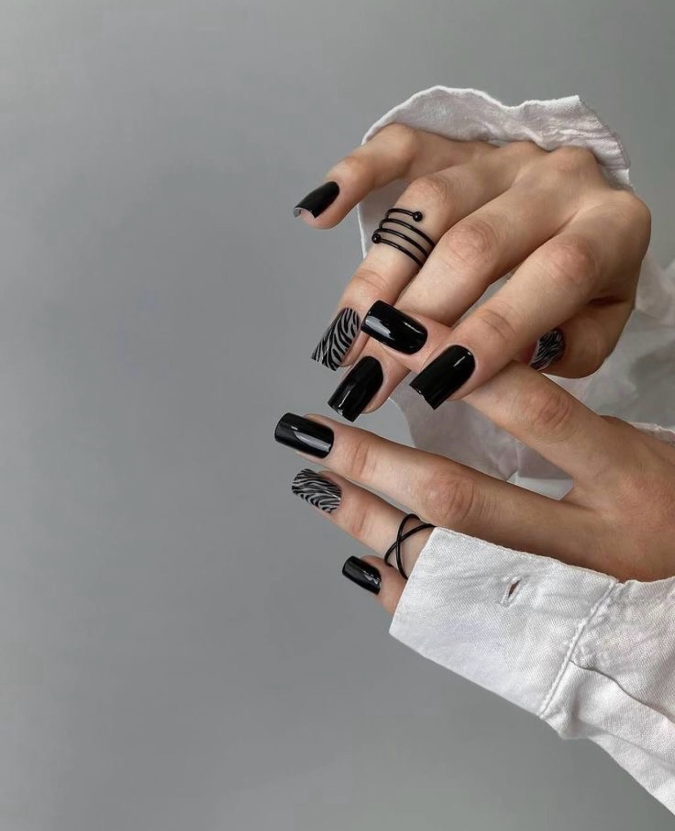 Glossy Black Nails with Zebra Print Accents