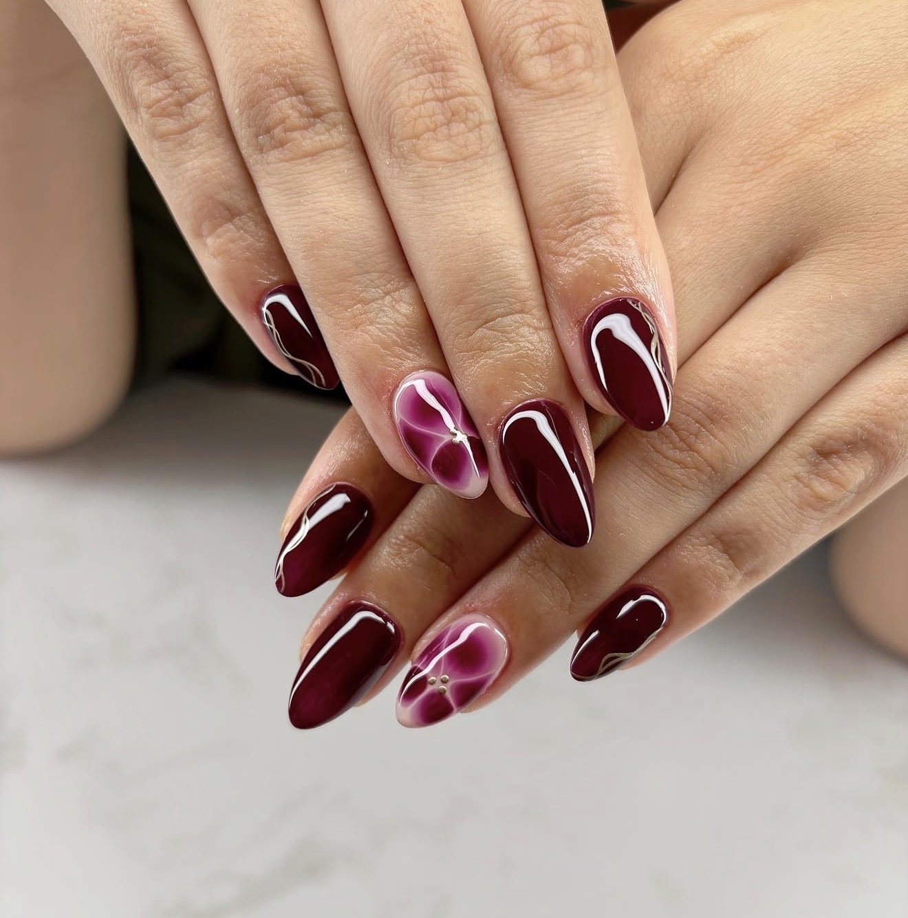 Glossy Deep Cherry Swirl Almond Nails