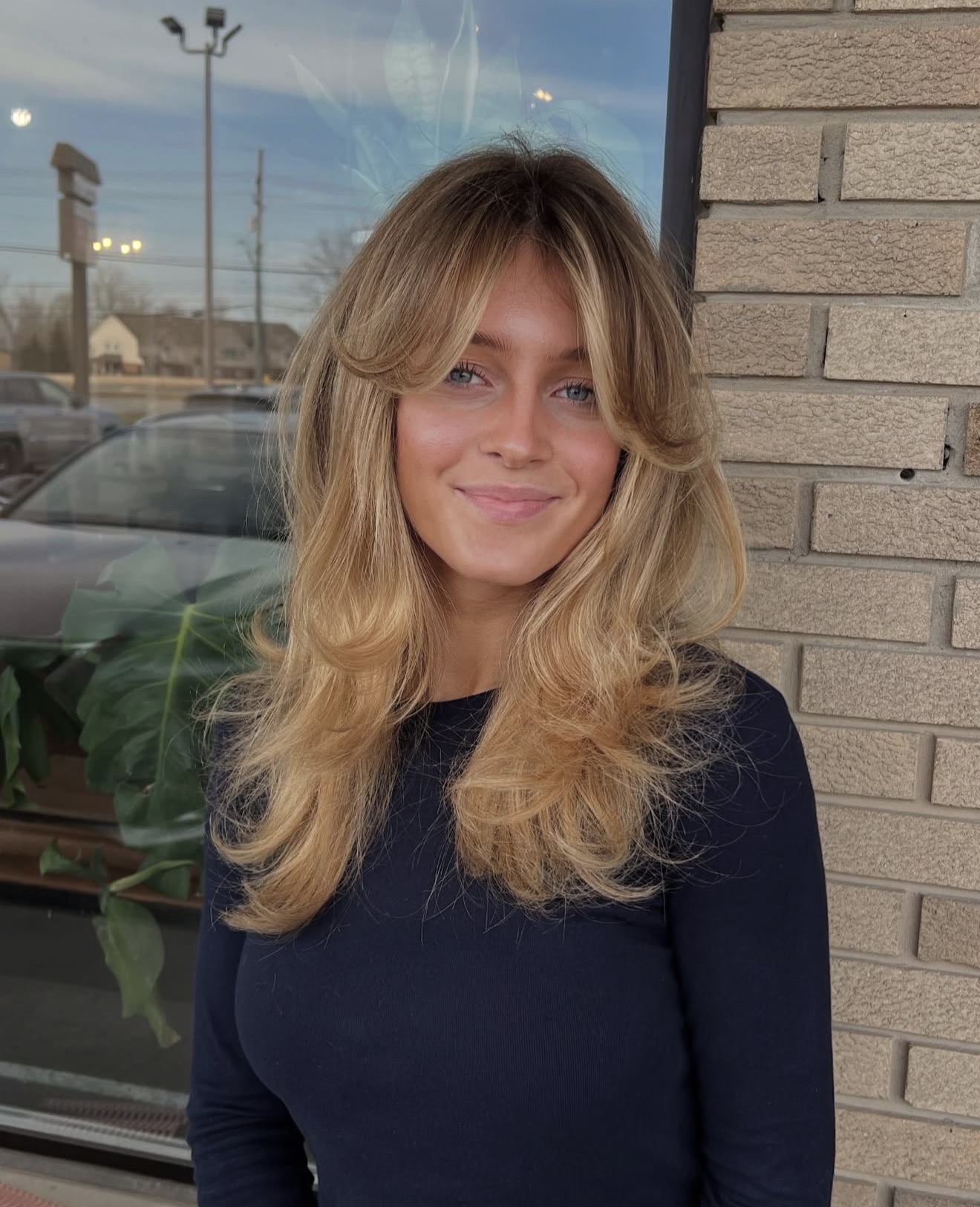 Honey Blonde Voluminous Layers With Curtain Bangs