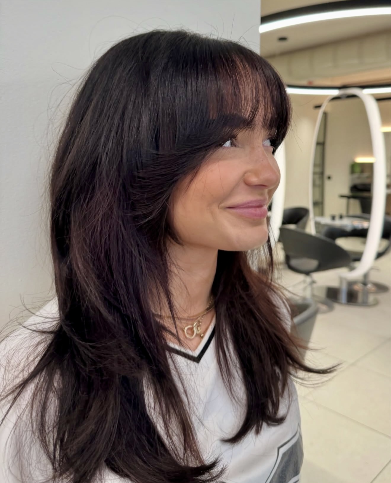 Layered Dark Brown Hair With Wispy Bangs