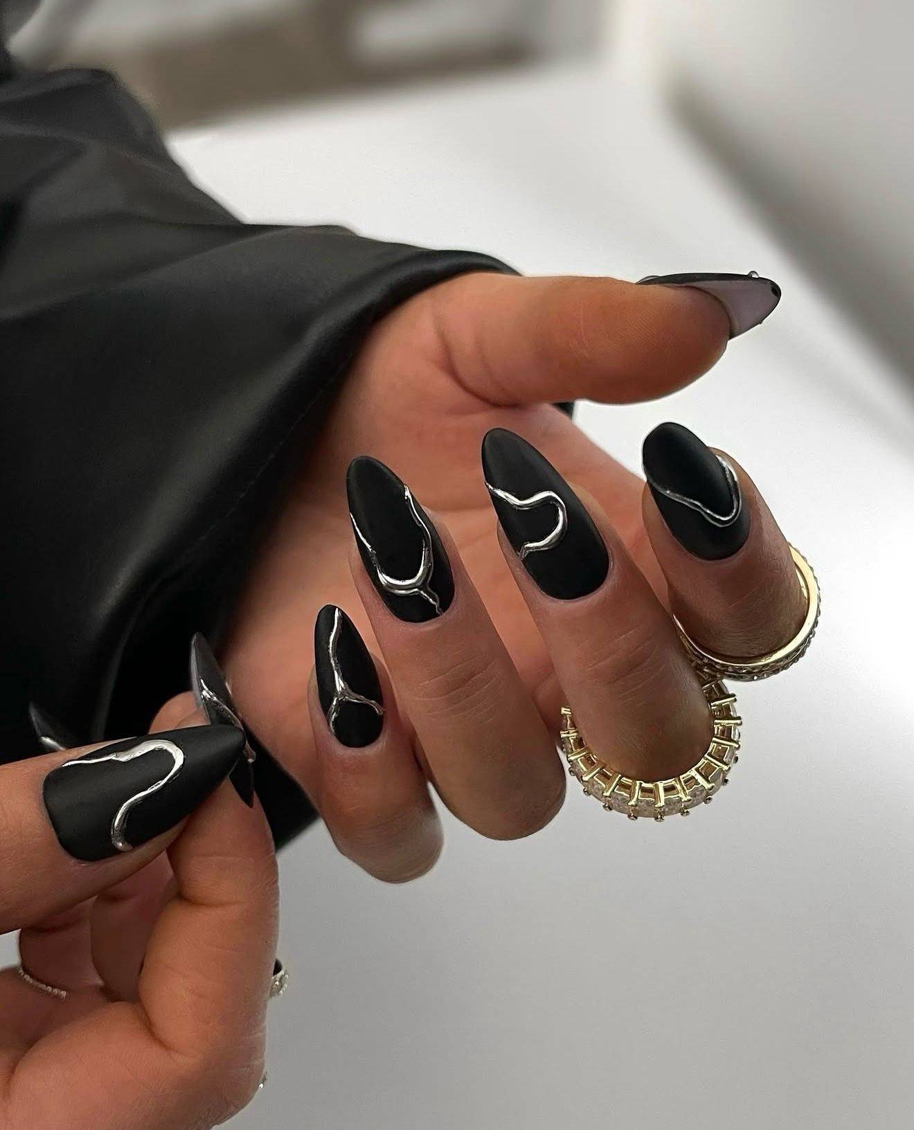 Matte Black Stiletto Nails With Silver Swirls