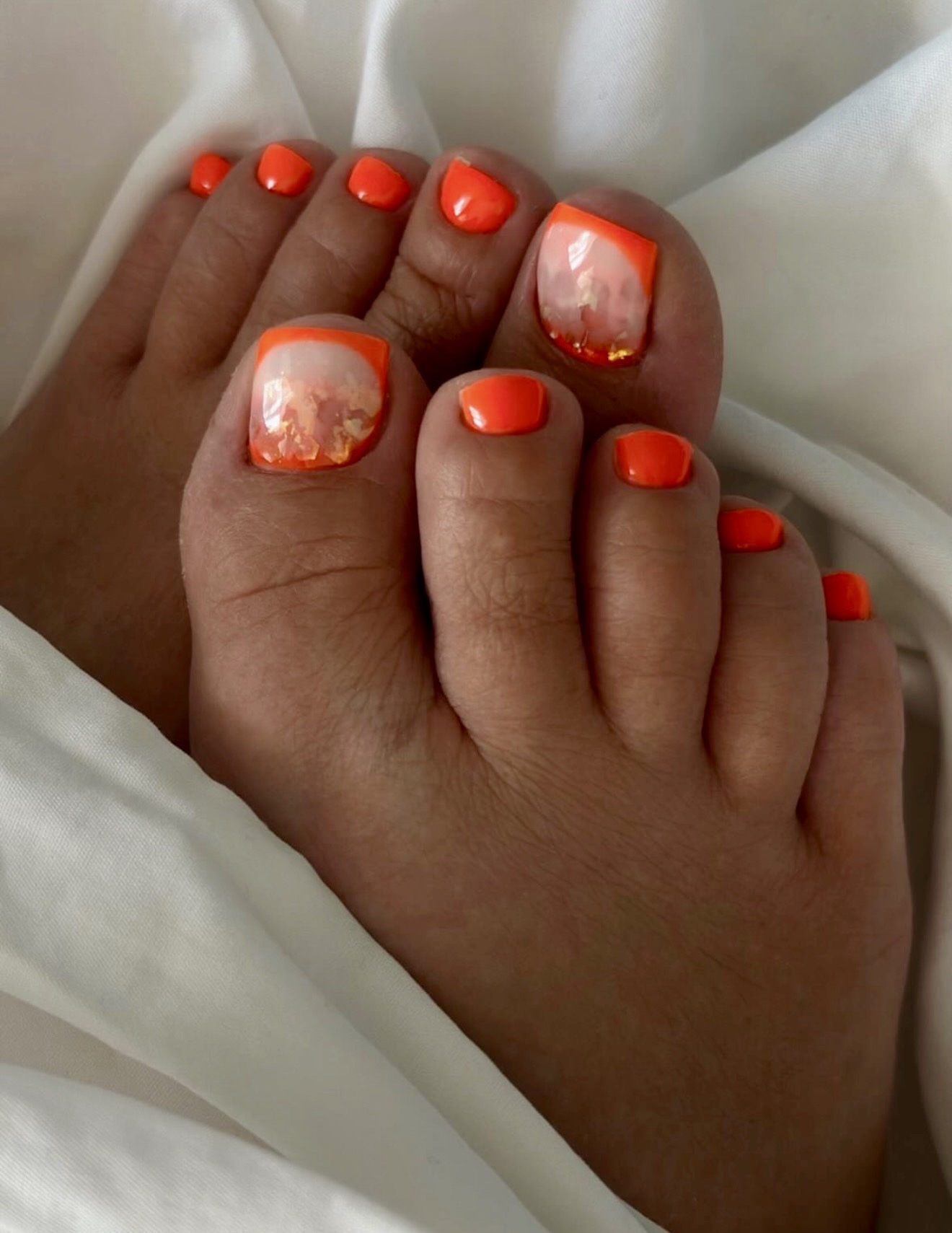 Orange French Tip Pedicure With Gold Flakes