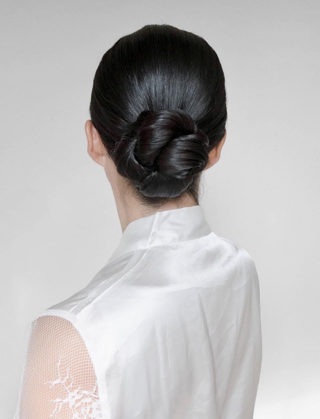 Sleek Braided Low Bun With Glossy Finish