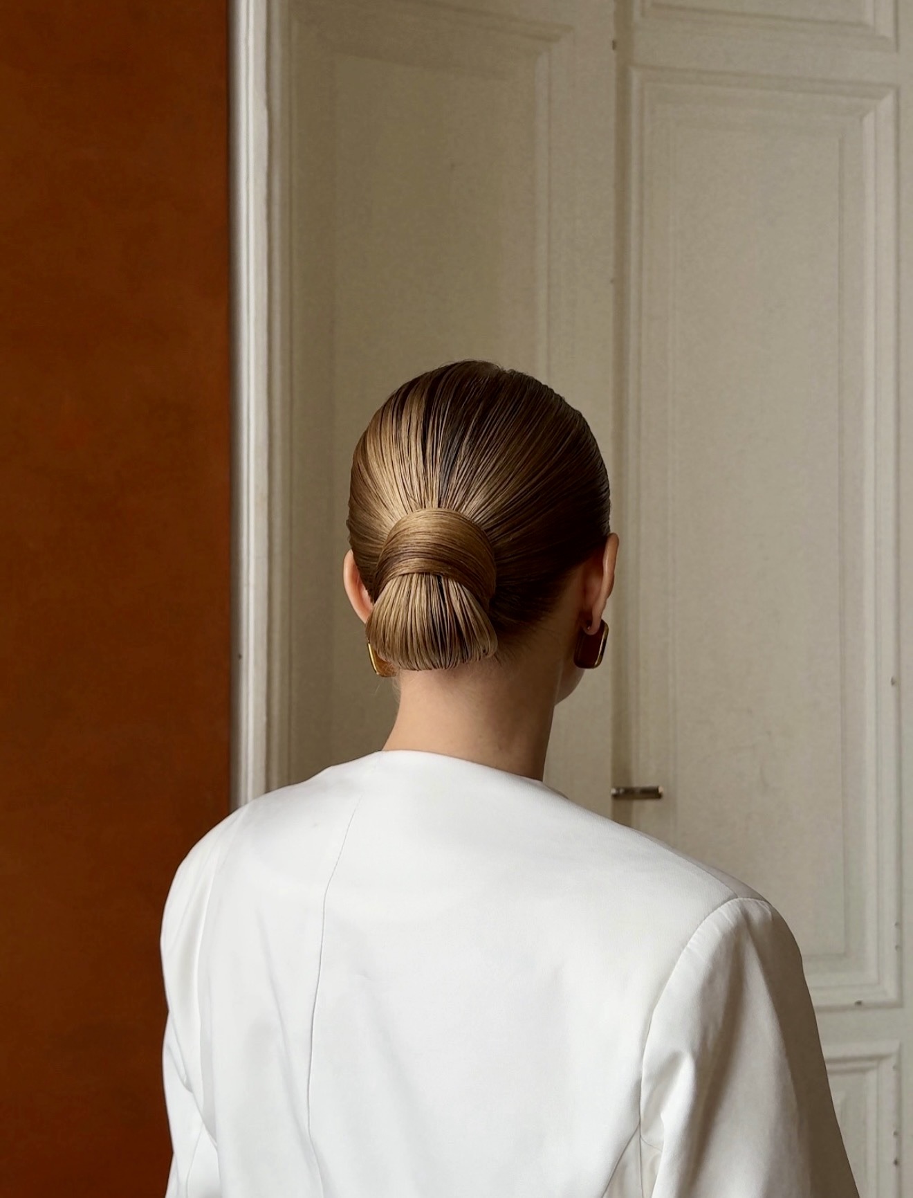 Sleek Low Twisted Bun With Golden Highlights