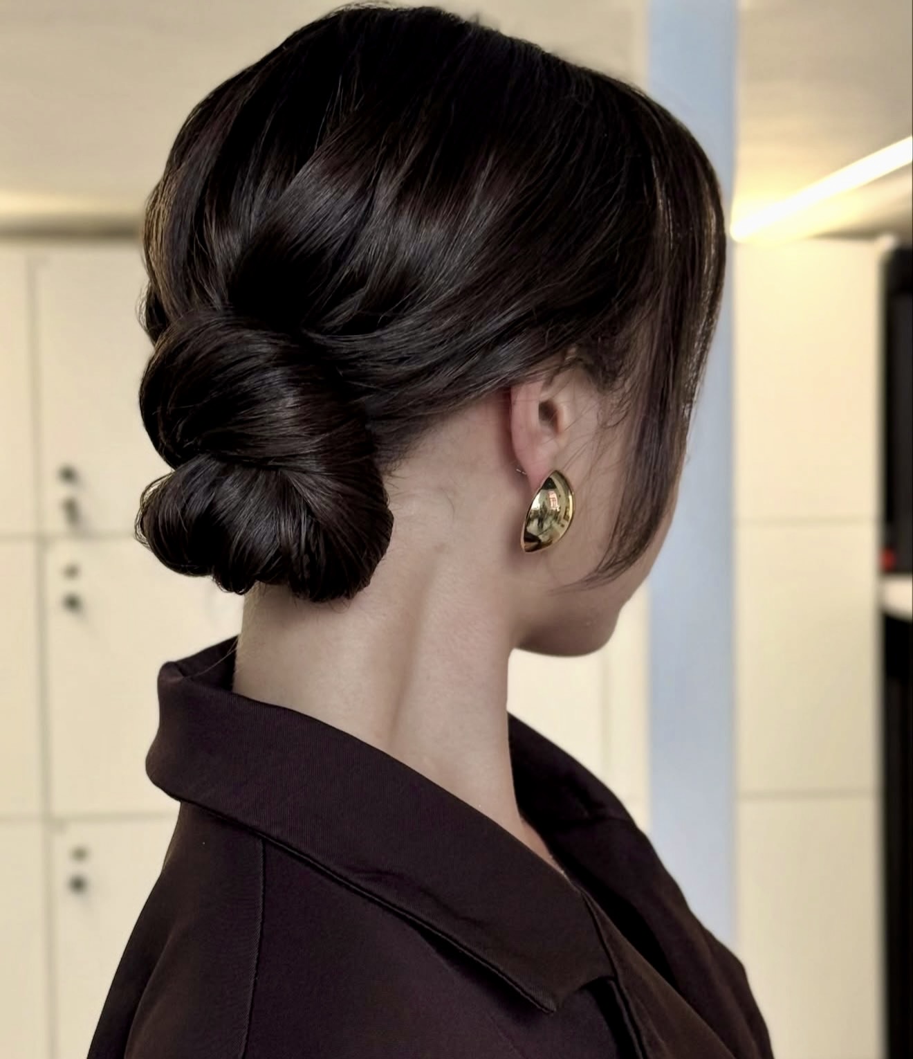 Sleek Twisted Low Bun With Face Framing Pieces