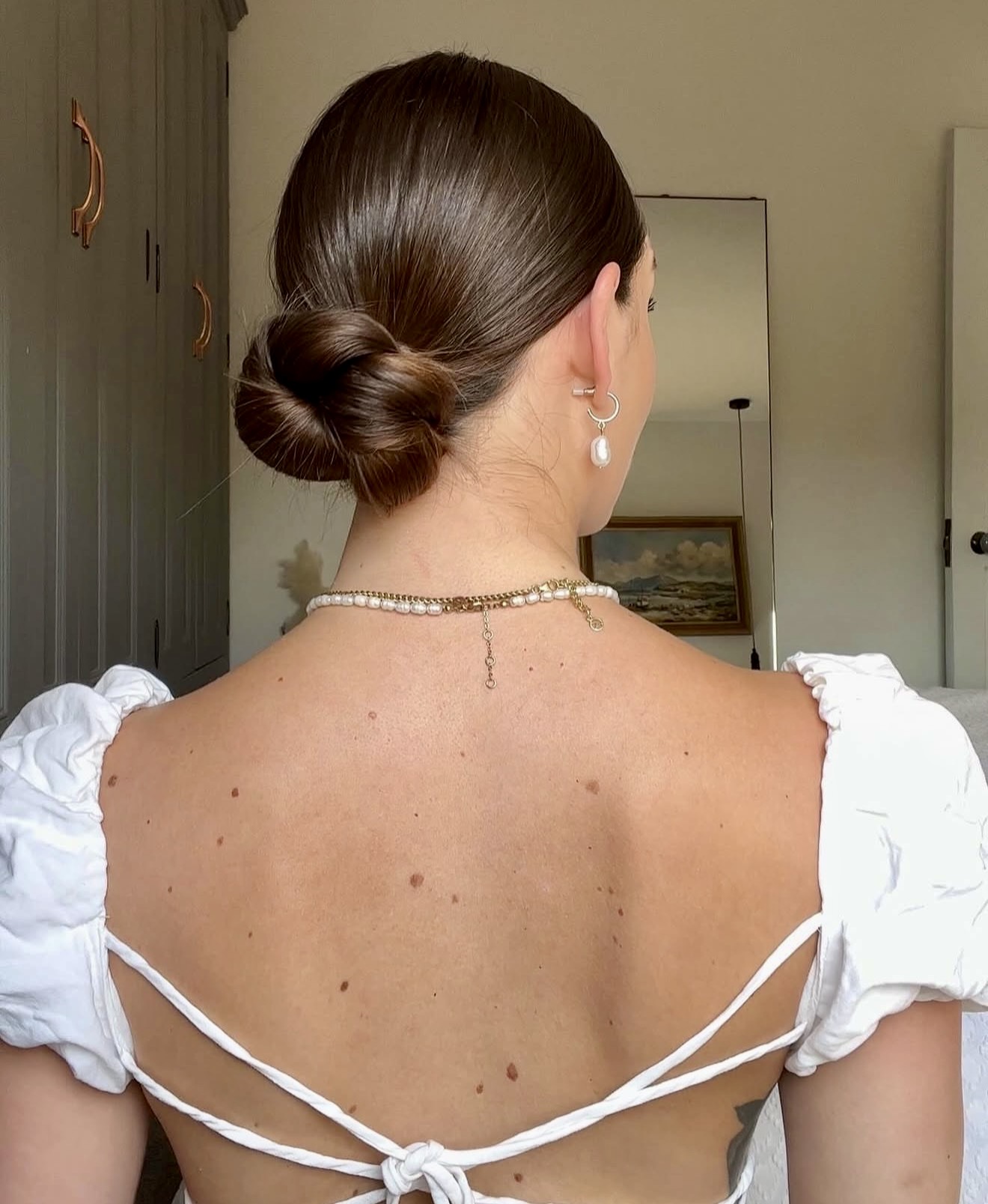 Sleek Twisted Low Bun With Subtle Shine