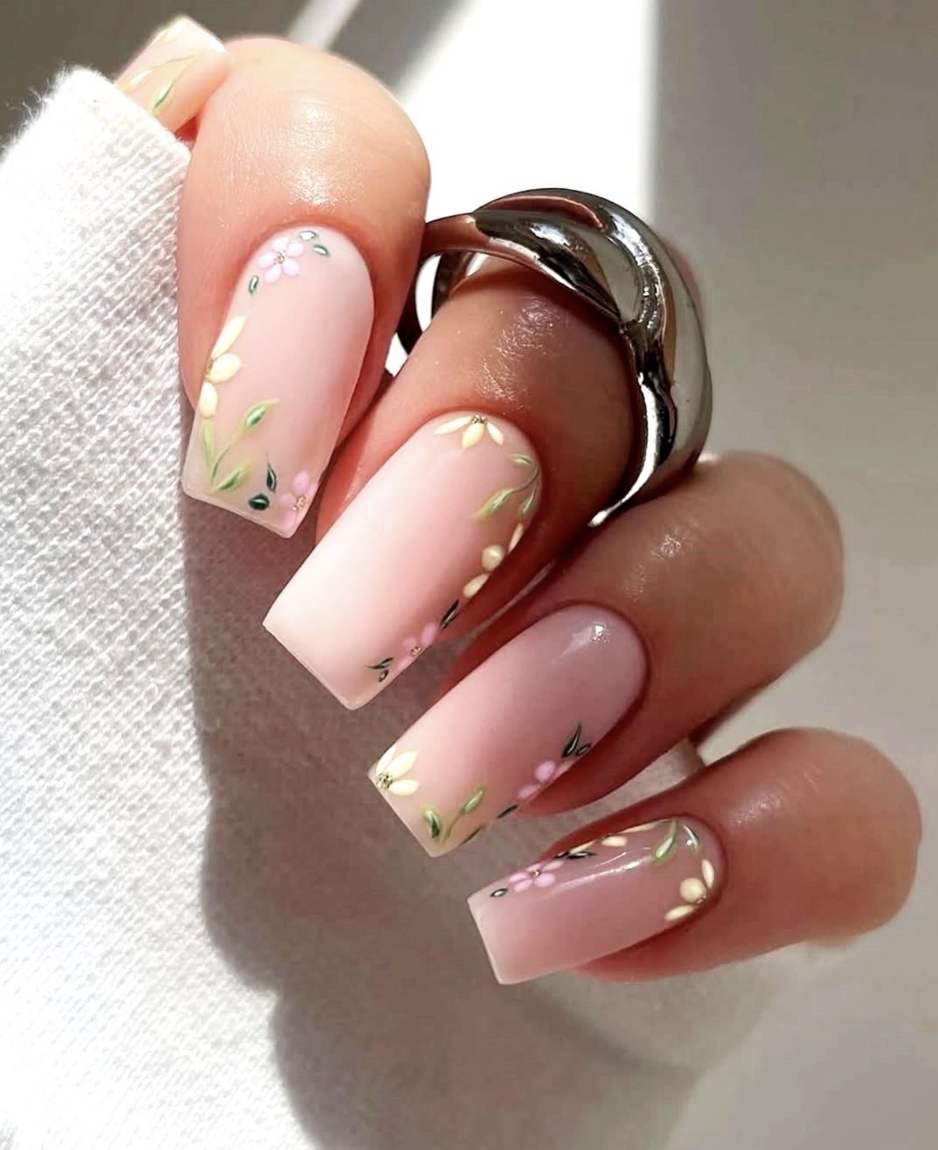 Soft Pink French Tip Nails with Delicate Floral Accents