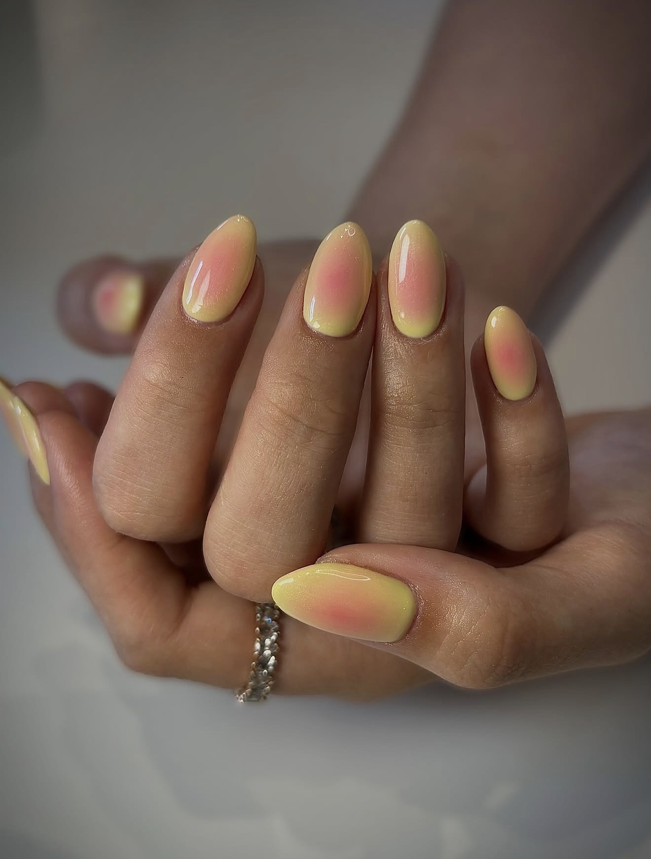Soft Yellow And Pink Aura Oval Nails