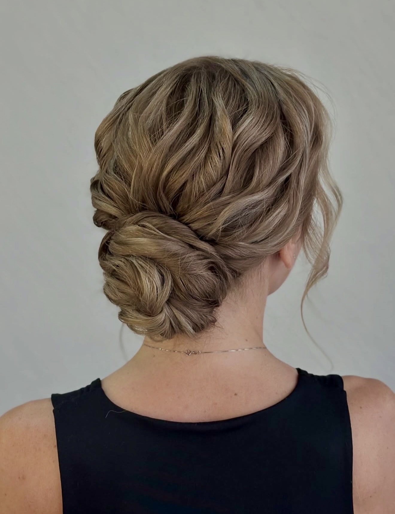 Textured Low Chignon With Loose Face-Framing Strands