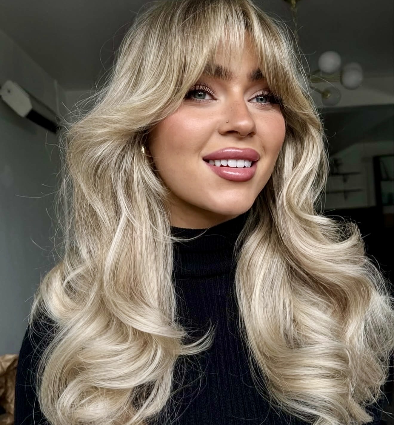 Voluminous Blonde Curls With Soft Curtain Bangs